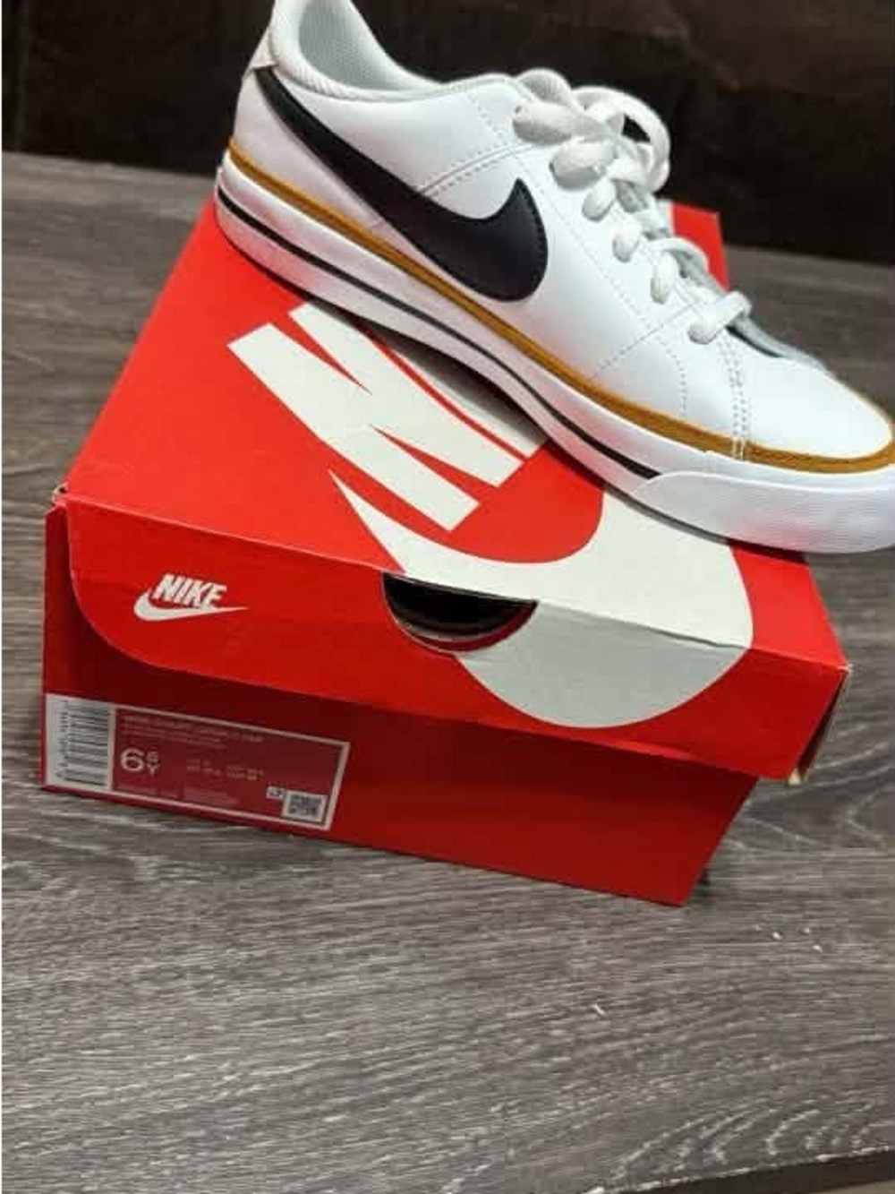 Nike White Kids Sneakers with Black Swoosh and Gold Trim